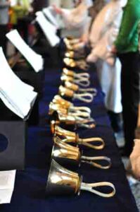 Gold Choir Bells on a blue velvet table