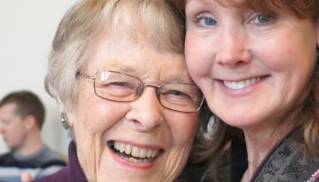 Two women, one older with glasses and the other with red hair